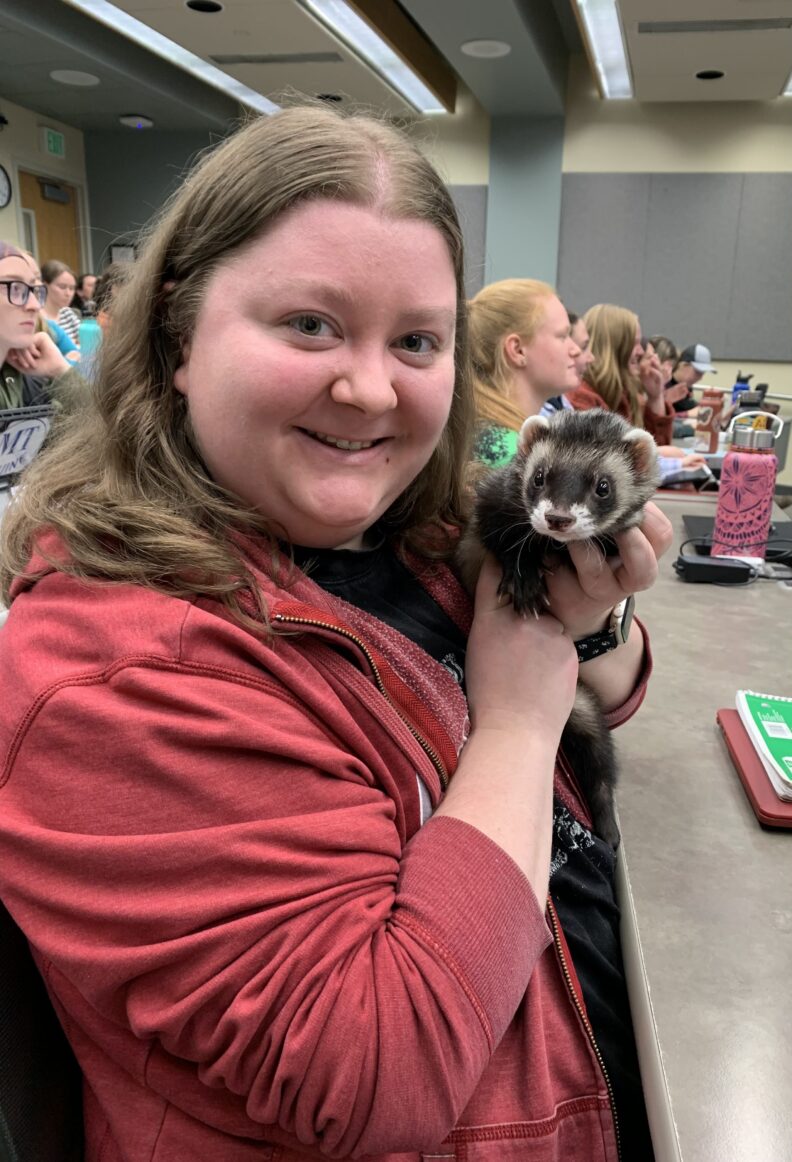 DVM student Brooklynn Balic stands with a cow