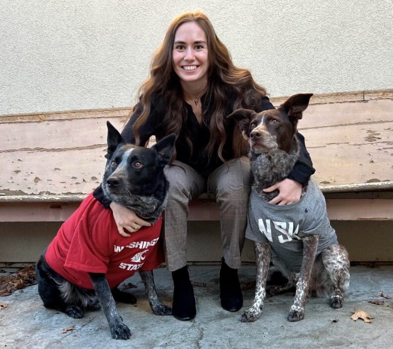 DVM student Brooklynn Balic stands with a cow