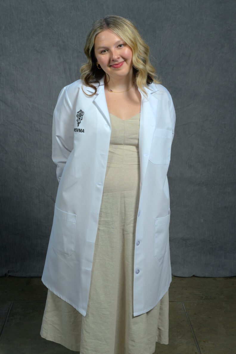 DVM student Brooklynn Balic stands with a cow