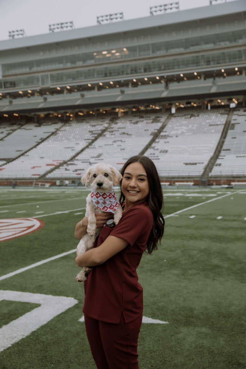 DVM student Brooklynn Balic stands with a cow