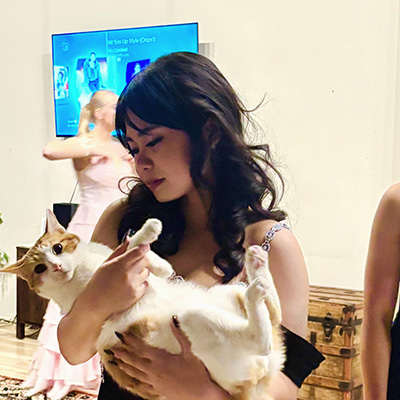 Kas De Castro holding her cat