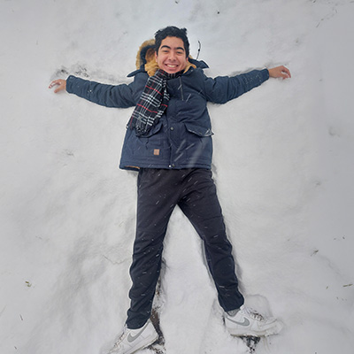 Luiz Takahashi making snow angels