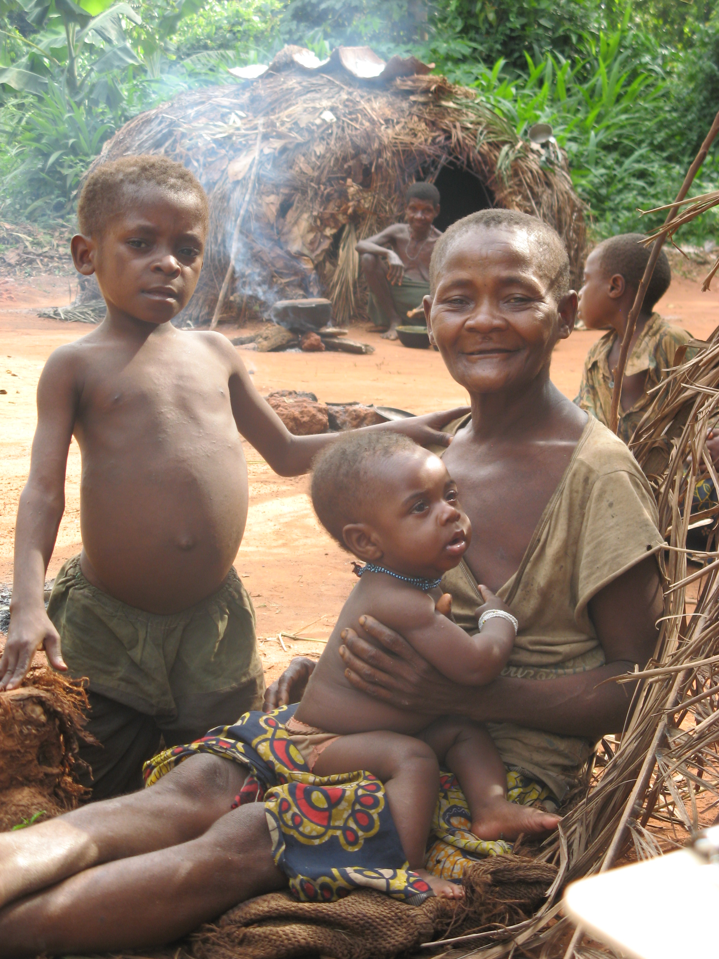 Aka grandmother and her grandchildren photographed in an African village.