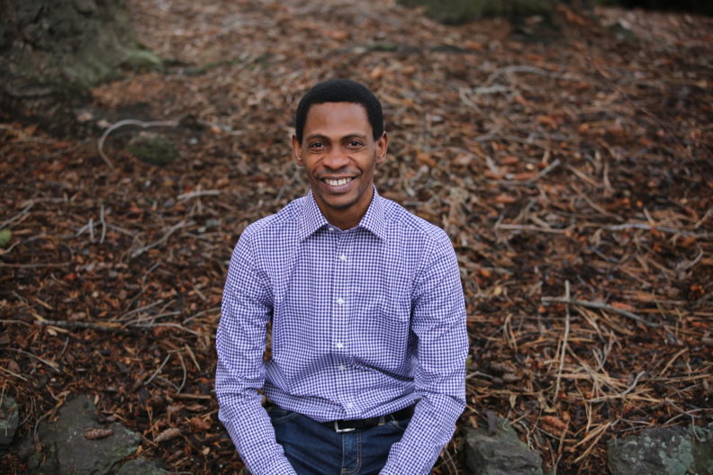 Oluwafemi Johnson Sunday smiling at camera.