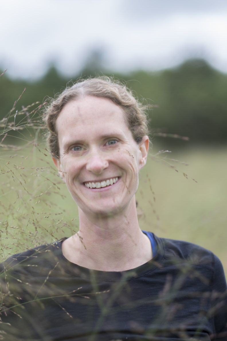 Sarah Roley next to switchgrass