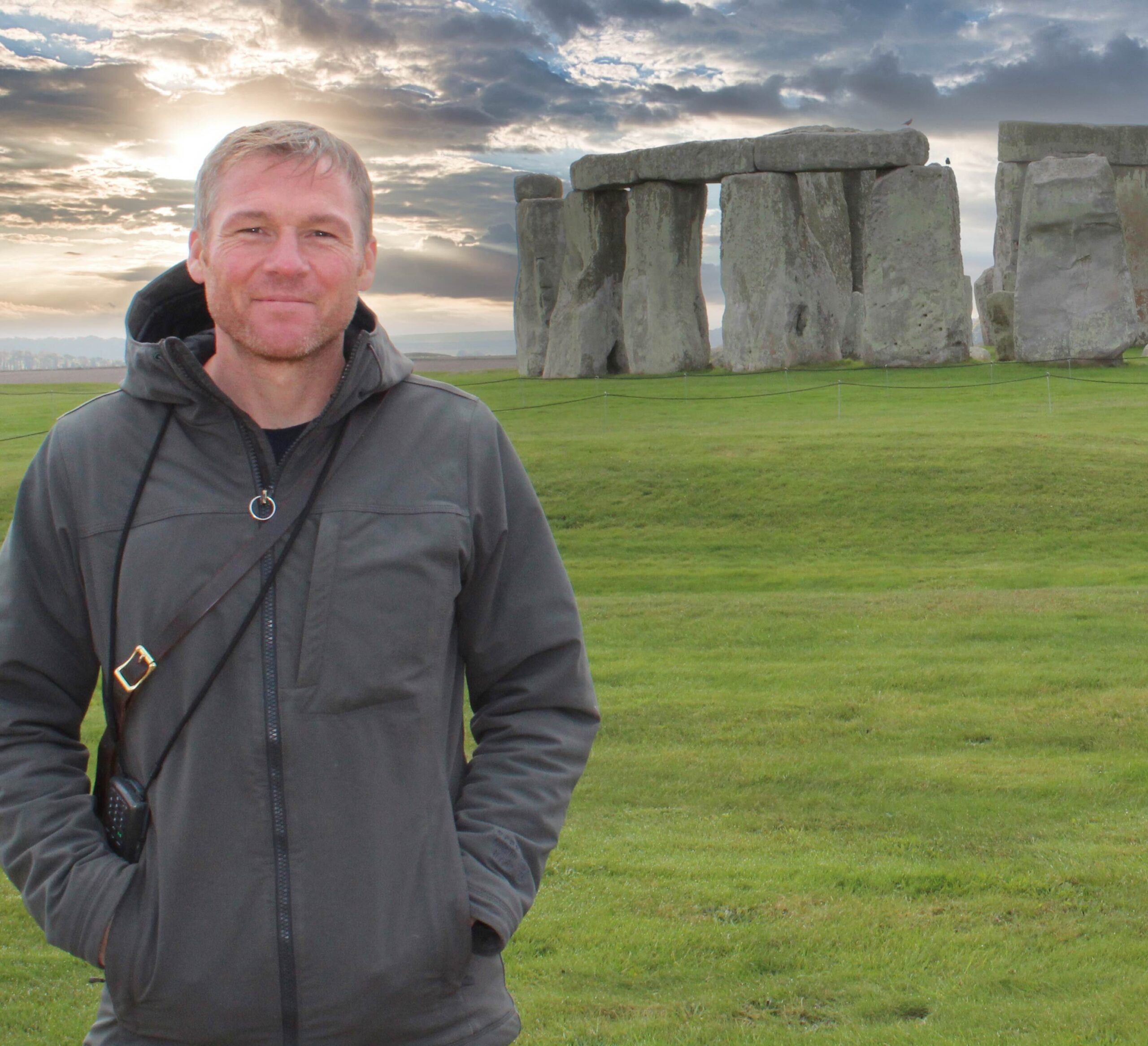 A portrait of Andy Cavagnetto standing in front of Stonehenge.