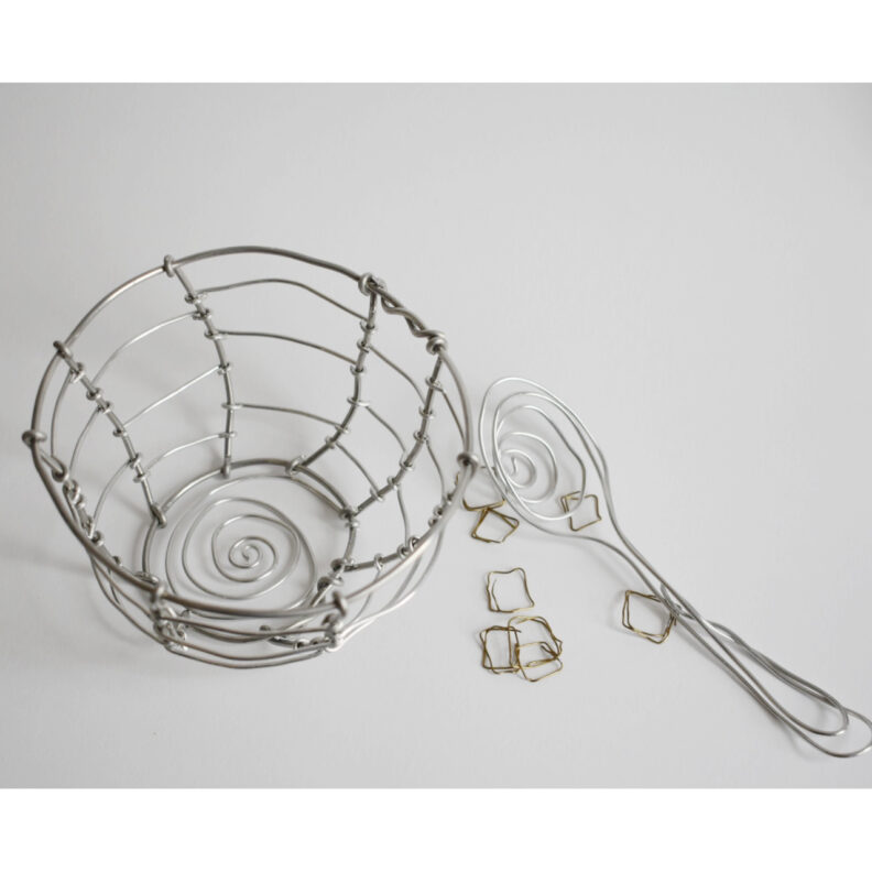 Aluminum wire sculpture of a bowl, spoon, and cereal.