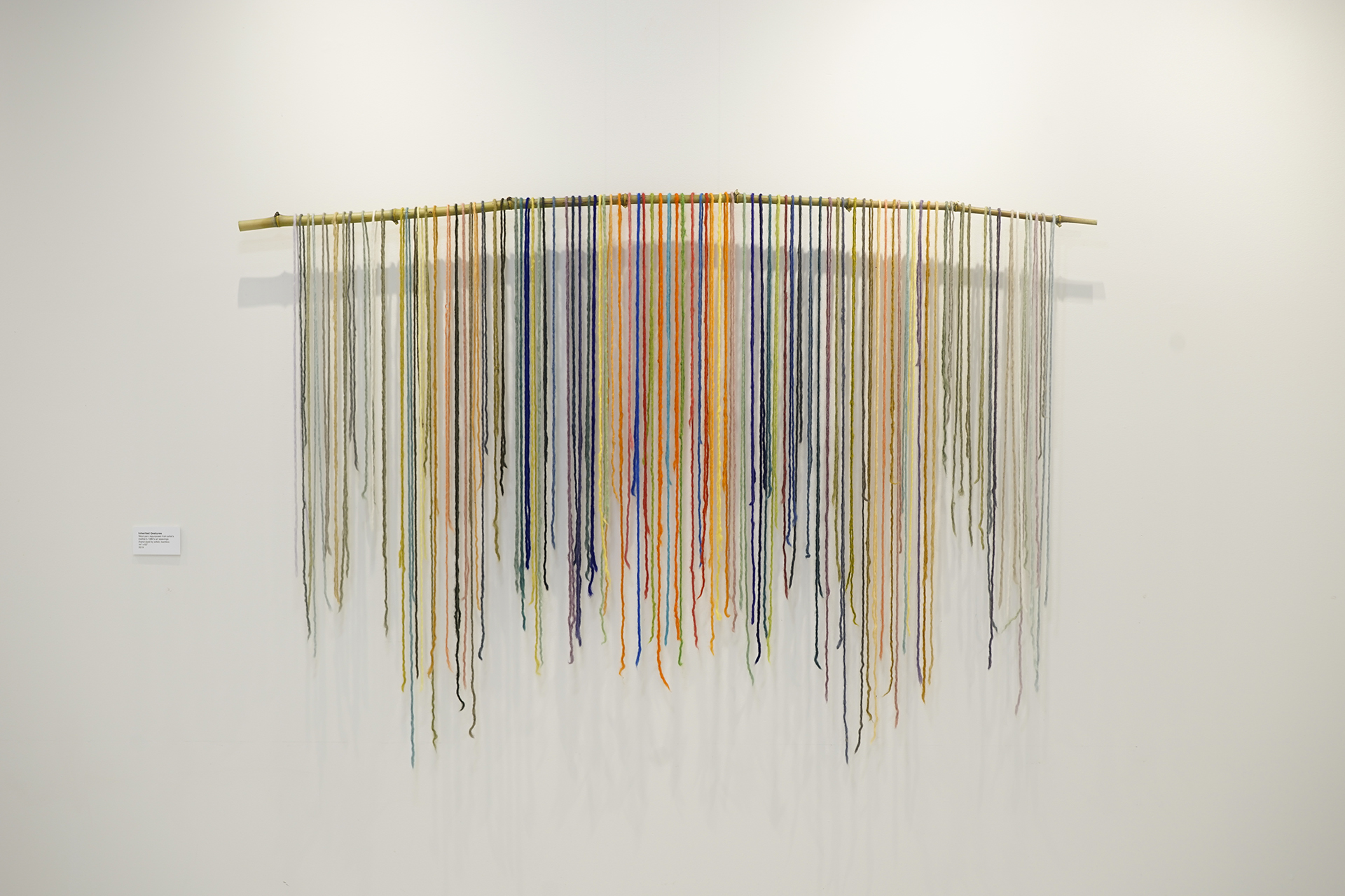 Yarn draped over a bamboo stick.