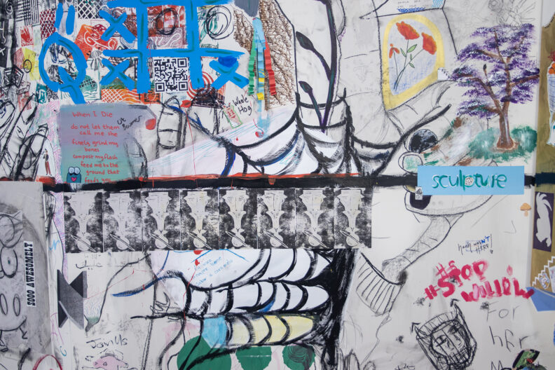 Zoomed in image of drawings and paintings on Karl's wall