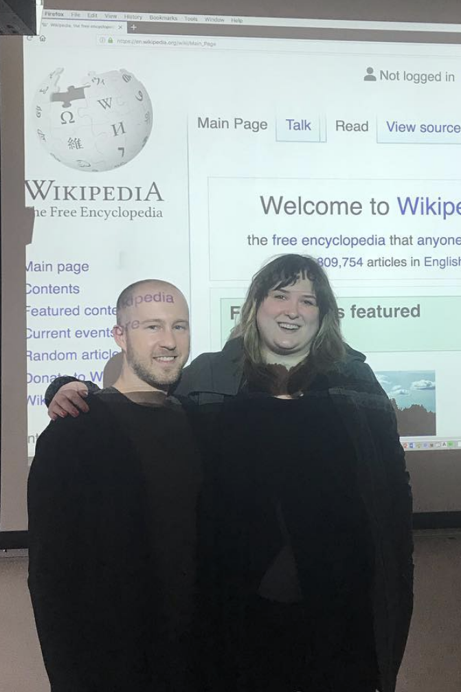 Group photo of Linden and Jason in front of a projector screen with wikipedia.