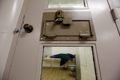 An inmate huddles under a heavy blanket in Pierce County Jail