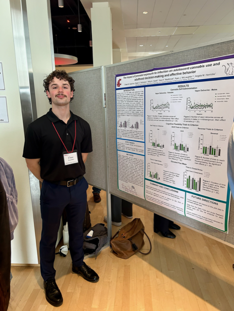 Chase Guenther in front of his poster at SURCA