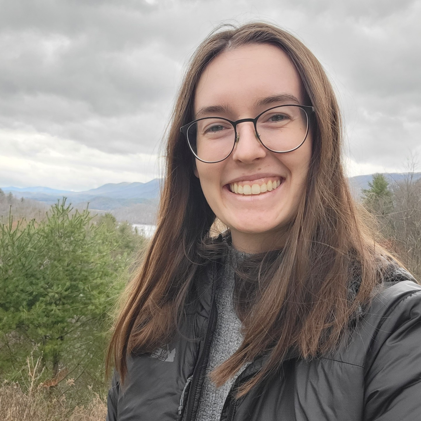 Madeline Zwergel smiling with a mountain range behind her