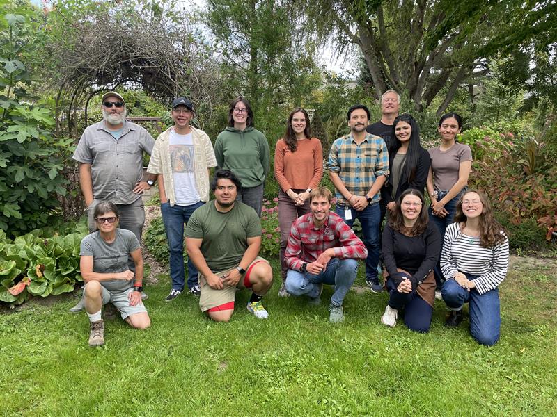 Group photo of members of the Soil Health and Soil and Water team, lined up facing the camera. Located in a garden.