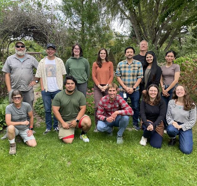 Group photo of members of the Soil Health and Soil and Water team, lined up facing the camera. Located in a garden.