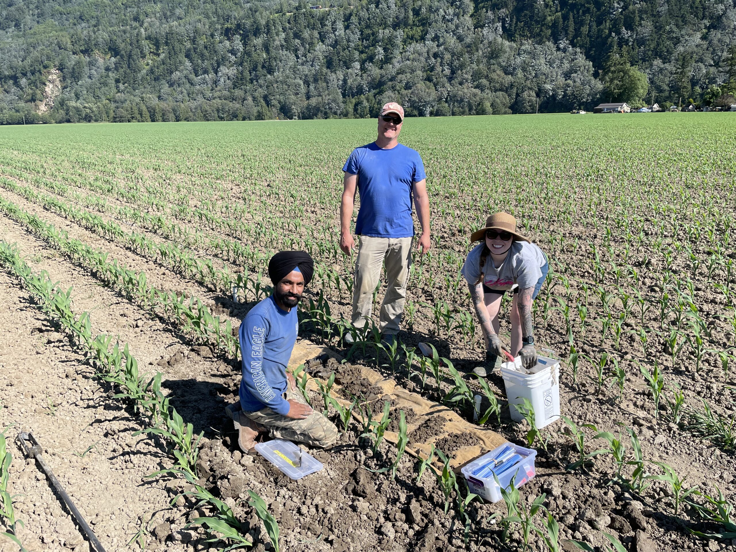 Three people in a field.