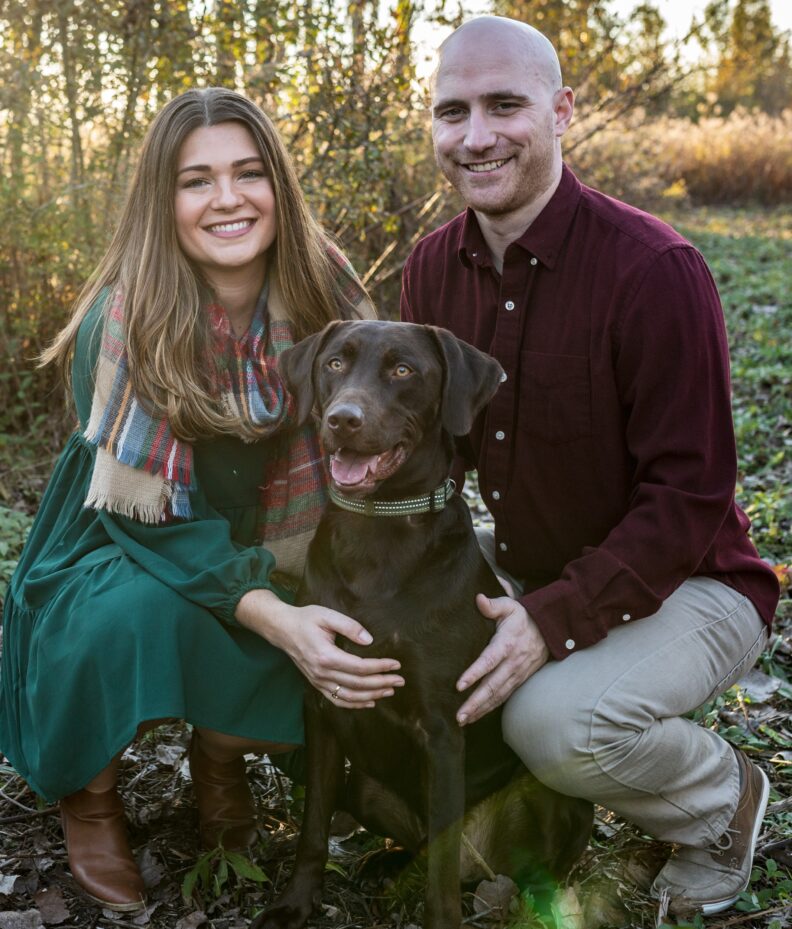Kye, a chocolate lab with his two humans.
