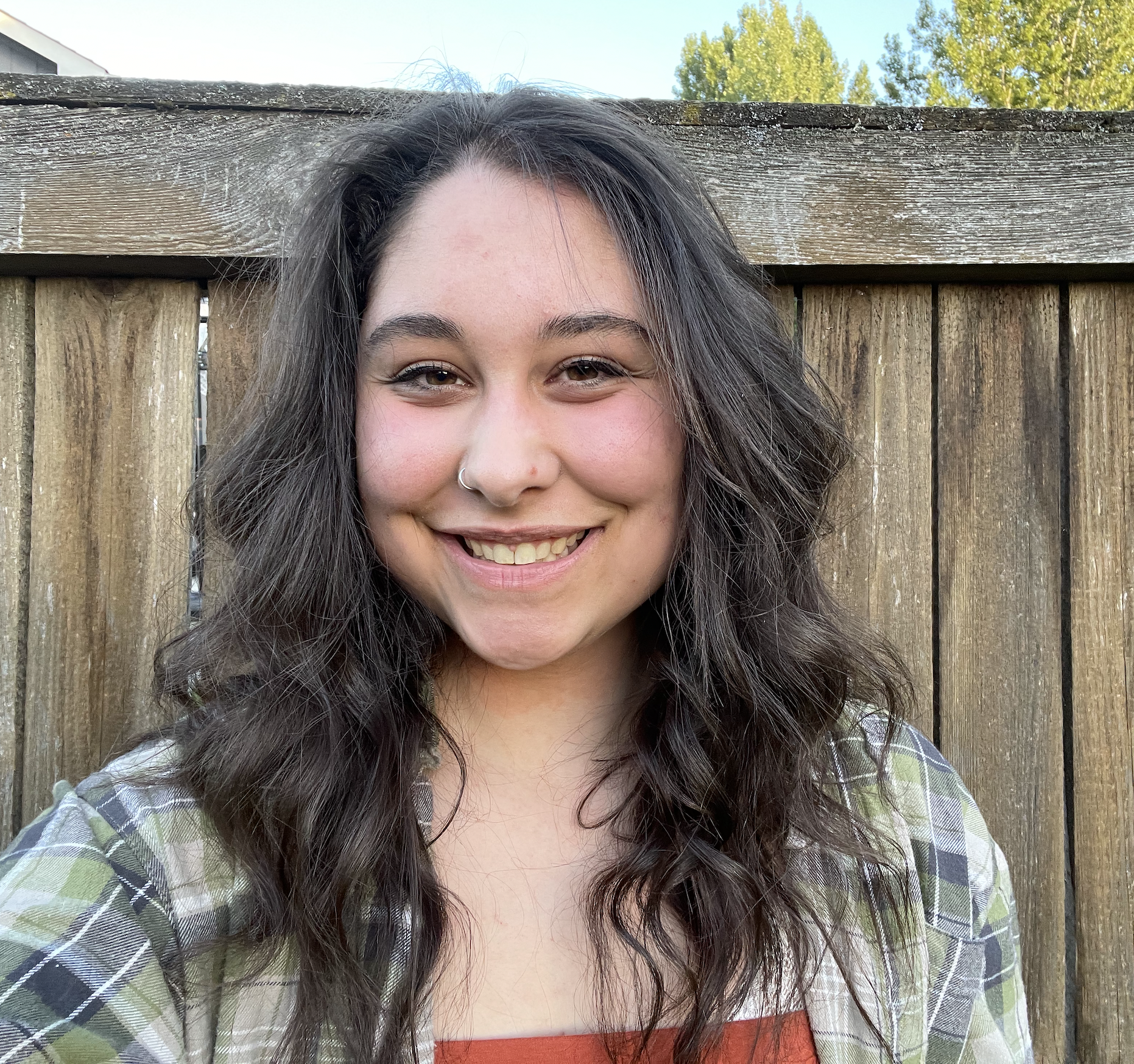 A woman with dark brown hair smiling.