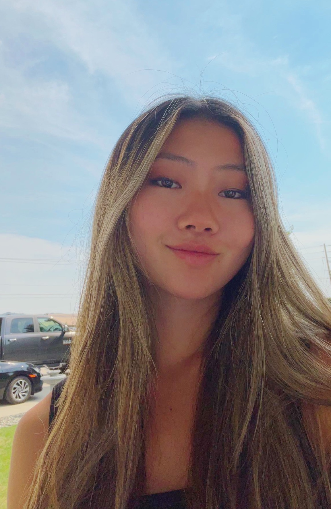 A woman with blond and brown hair smiling.