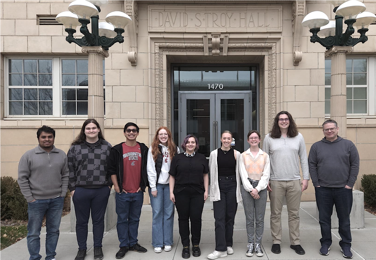 Group photo taken in Fall 2025 in front of Troy Hall at Washington State University. Pictured from left-to-right are Zaman, Thomas, Ethan, Molly, Kami, Ashlyn, Arthur, Christian, and Kevin. 