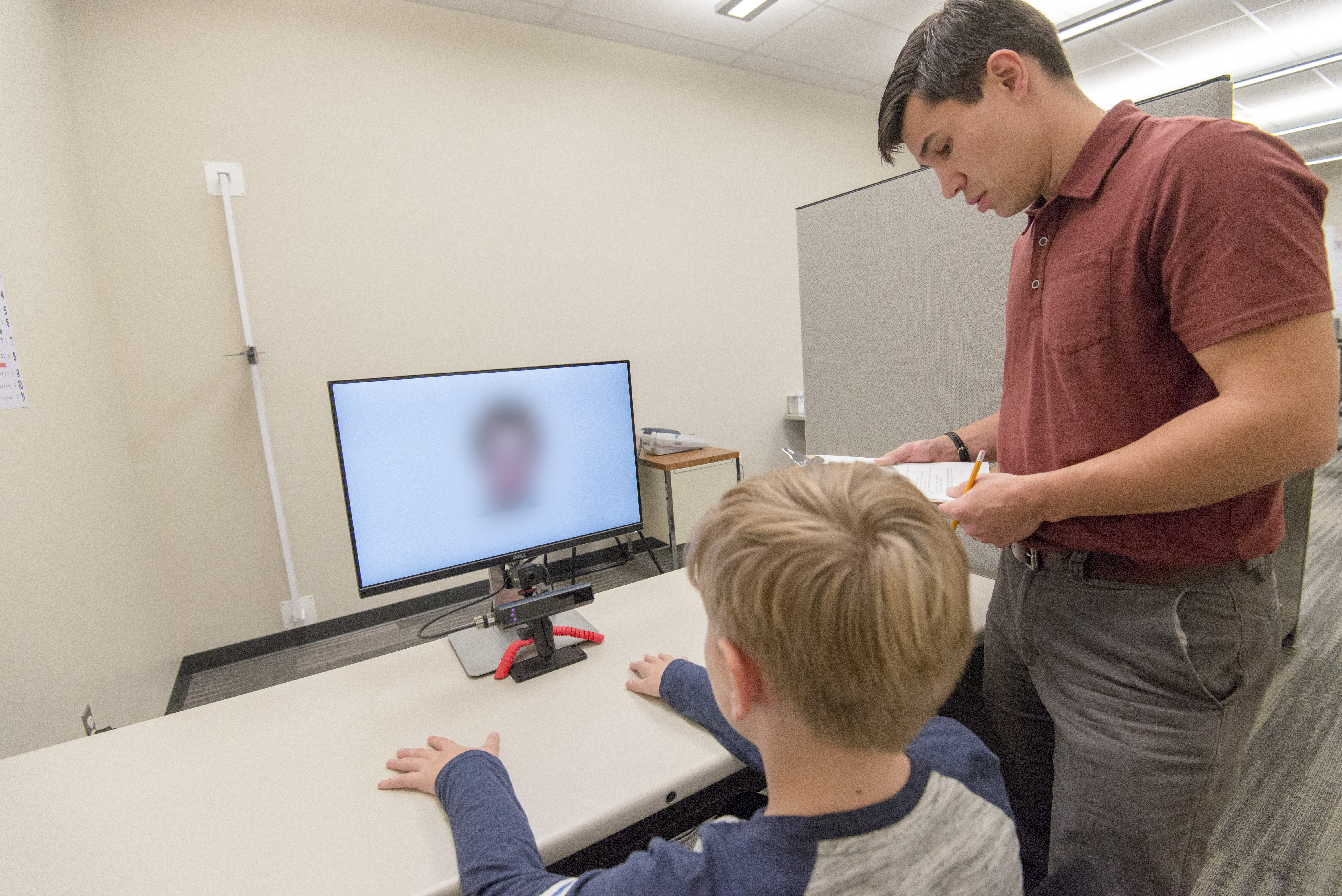 Child taking an eye tracking test at computer