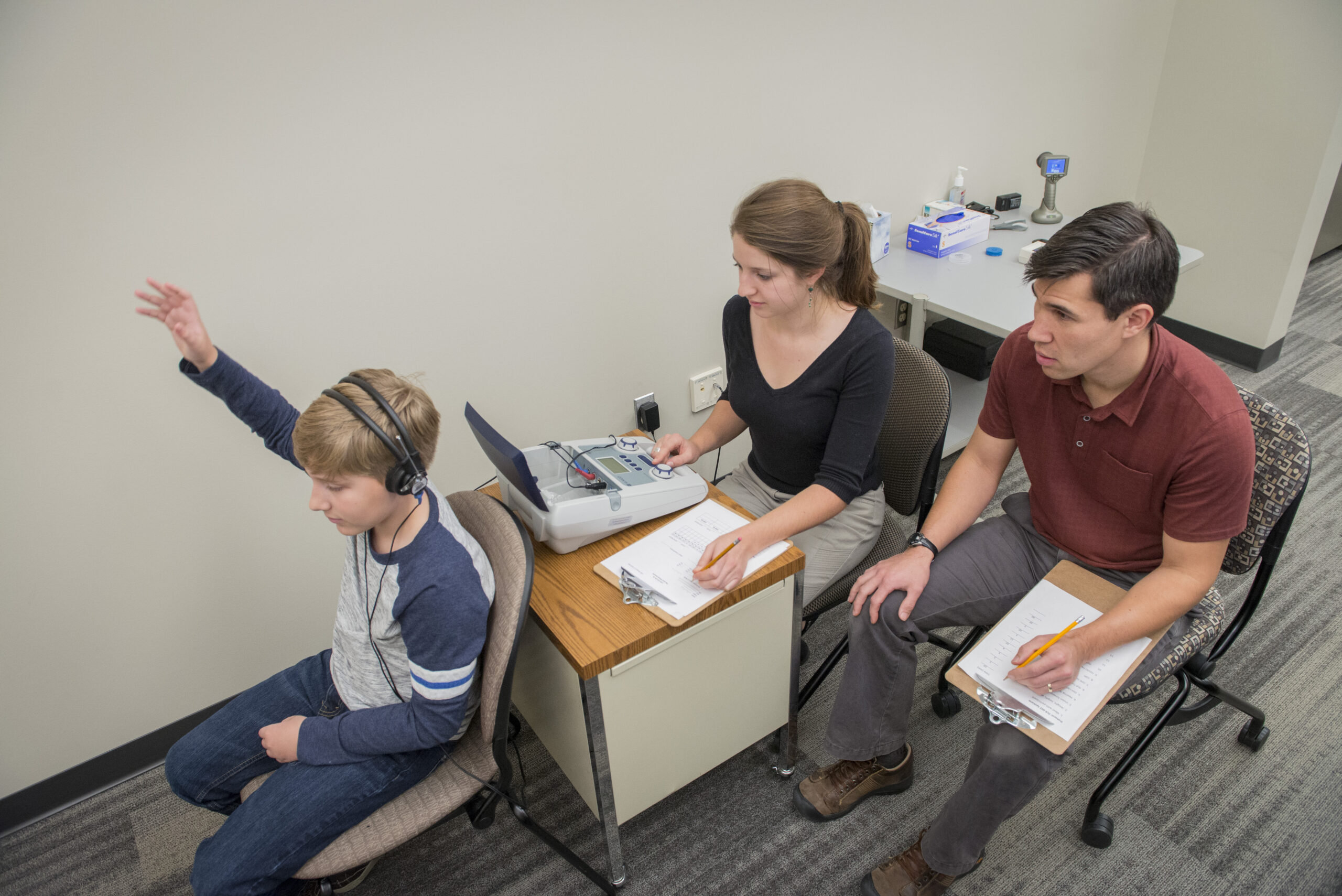 Child taking a hearing test using audiometer