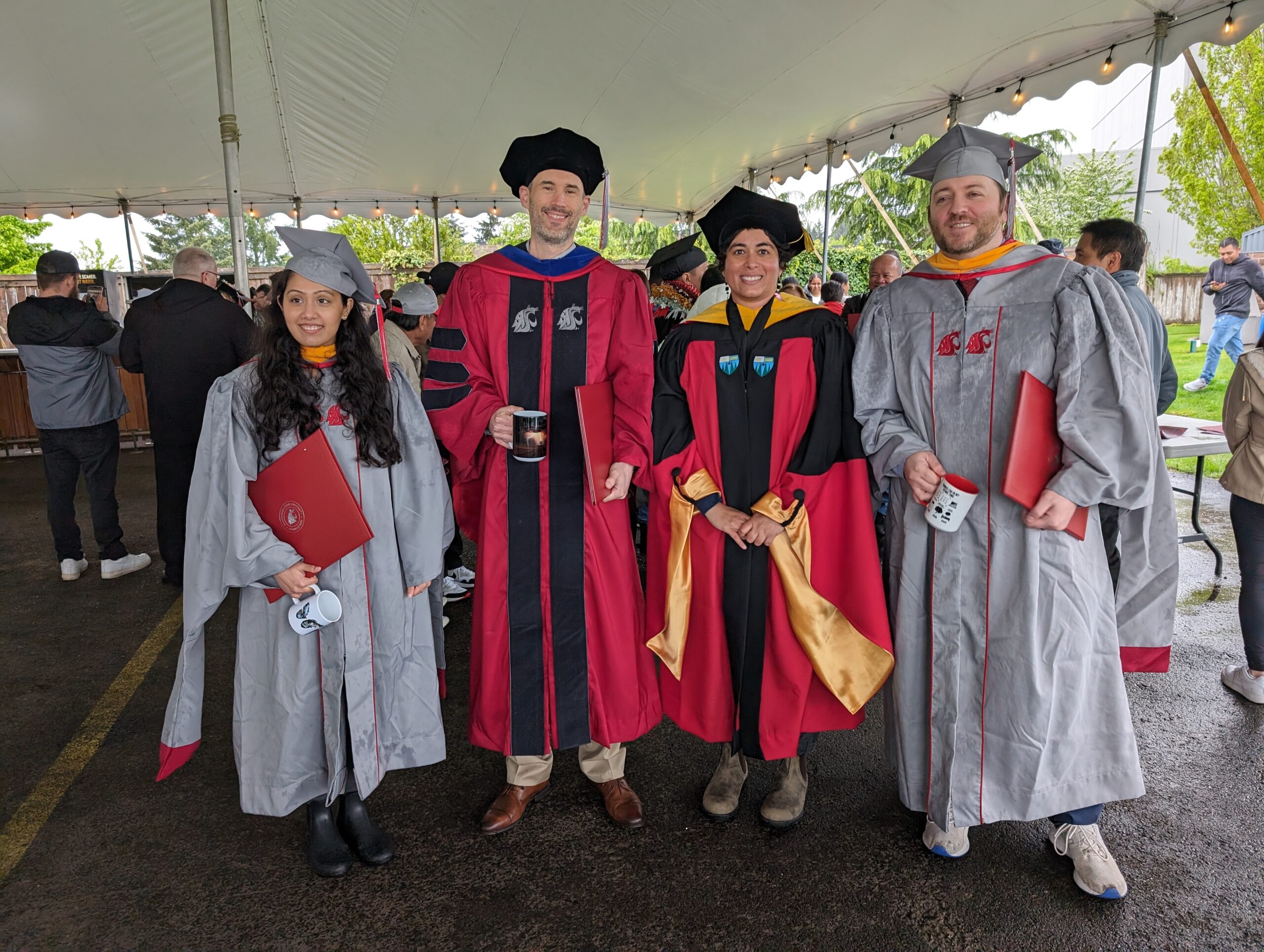 Masters and doctoral students in regalia at graduation.