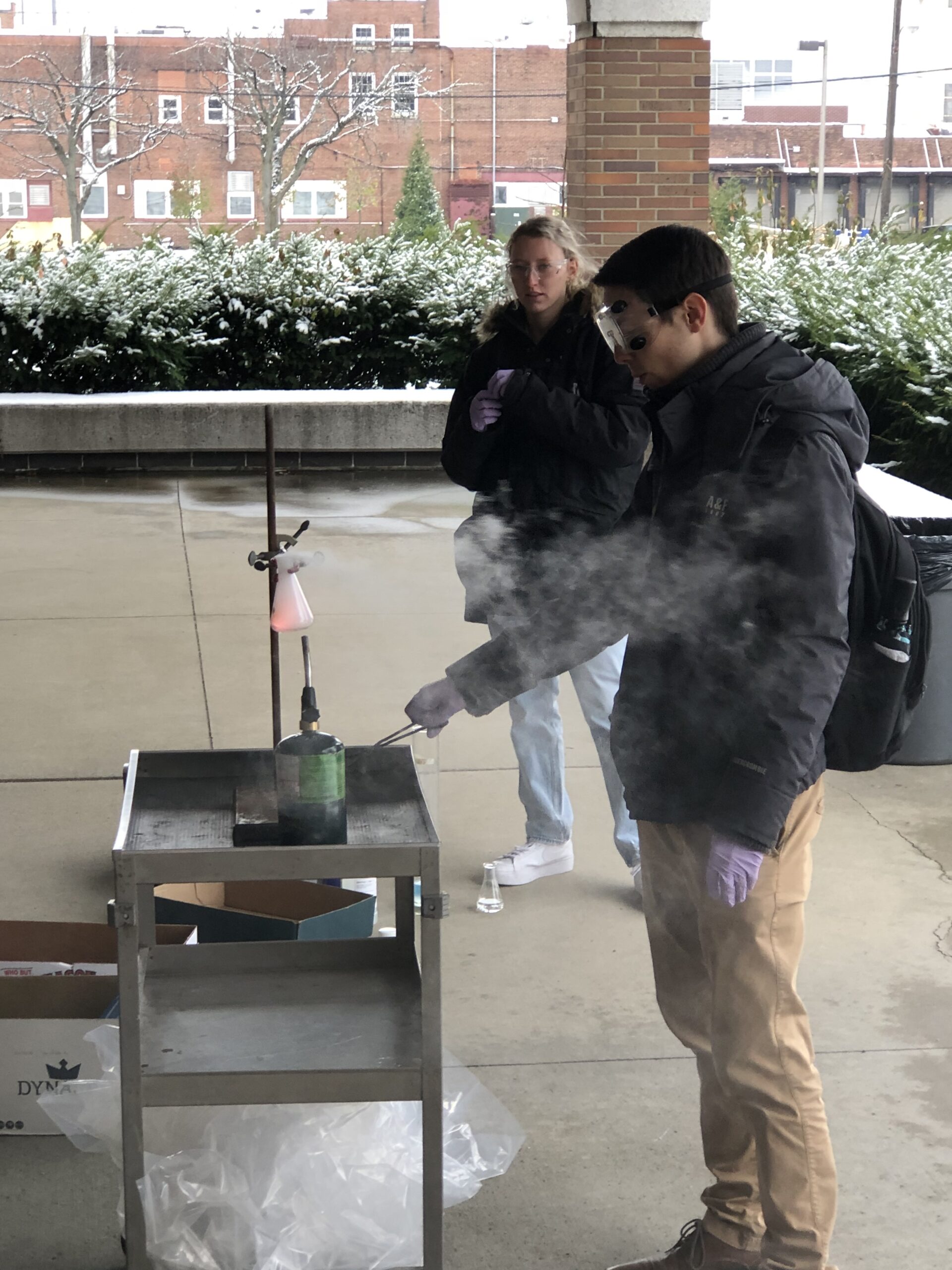 Chad Studvick and Alexis Kiefer performing the flaming gummy bear reaction