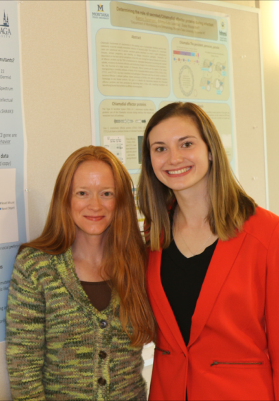 TAYLOR standing in front of her poster