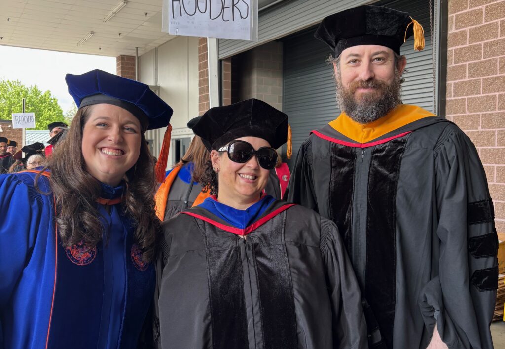 A photo of Drs. Bletscher, Jenkins, and Spradlin in their doctoral regalia at WSUV Commencement 2025