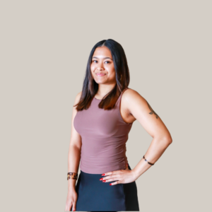 Photo of Aaliyah standing in pink shirt. 