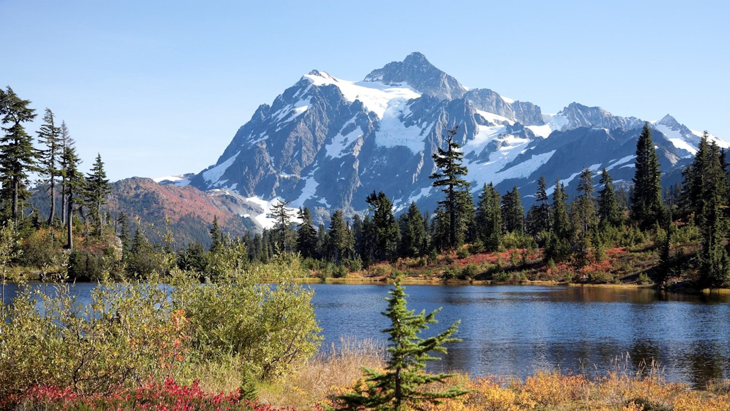 Photograph of a large mountain with a lake in the foreground