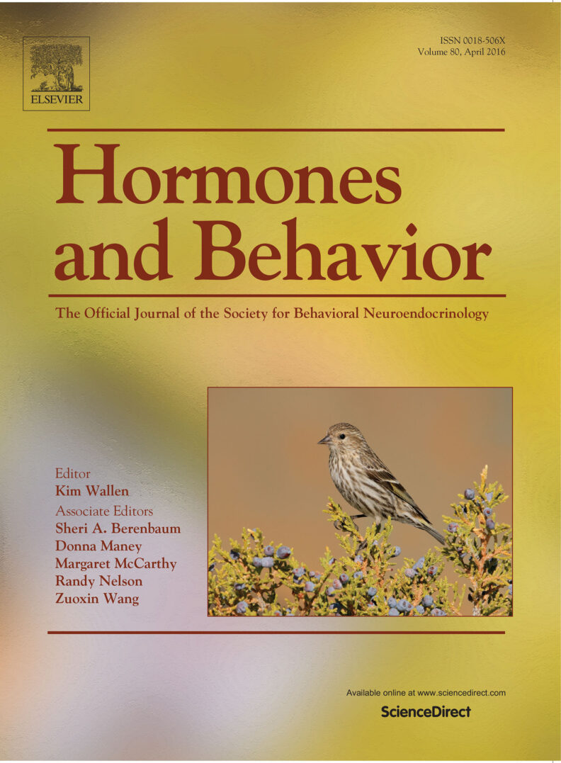 Cover of Hormones and Behavior journal showing a pine siskin photo. 