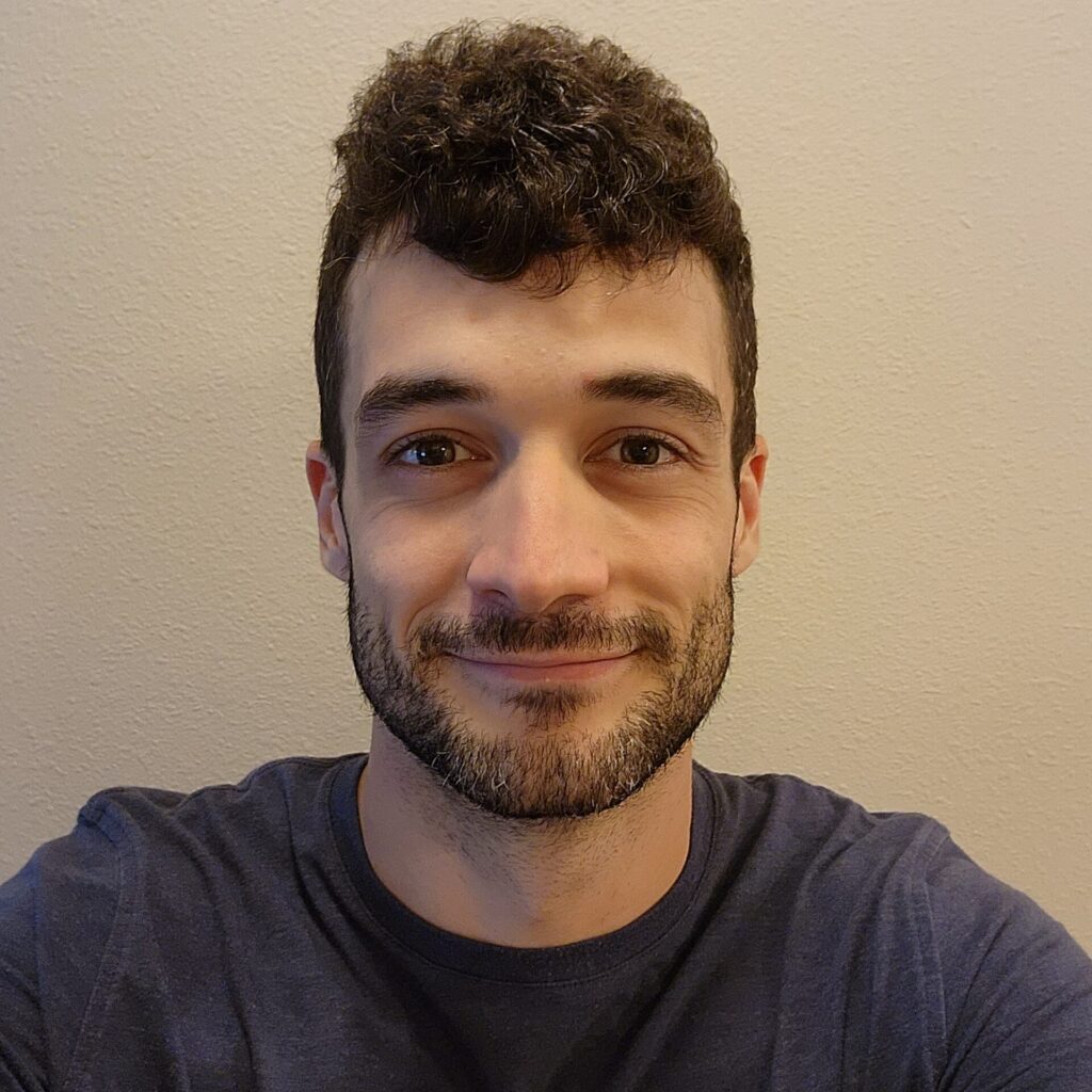 Austin Bryan in sports t-shirt in front of wall