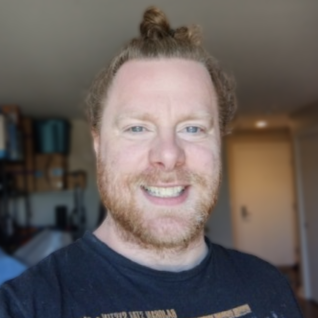 Jeremy Banks in a navy t-shirt smiling