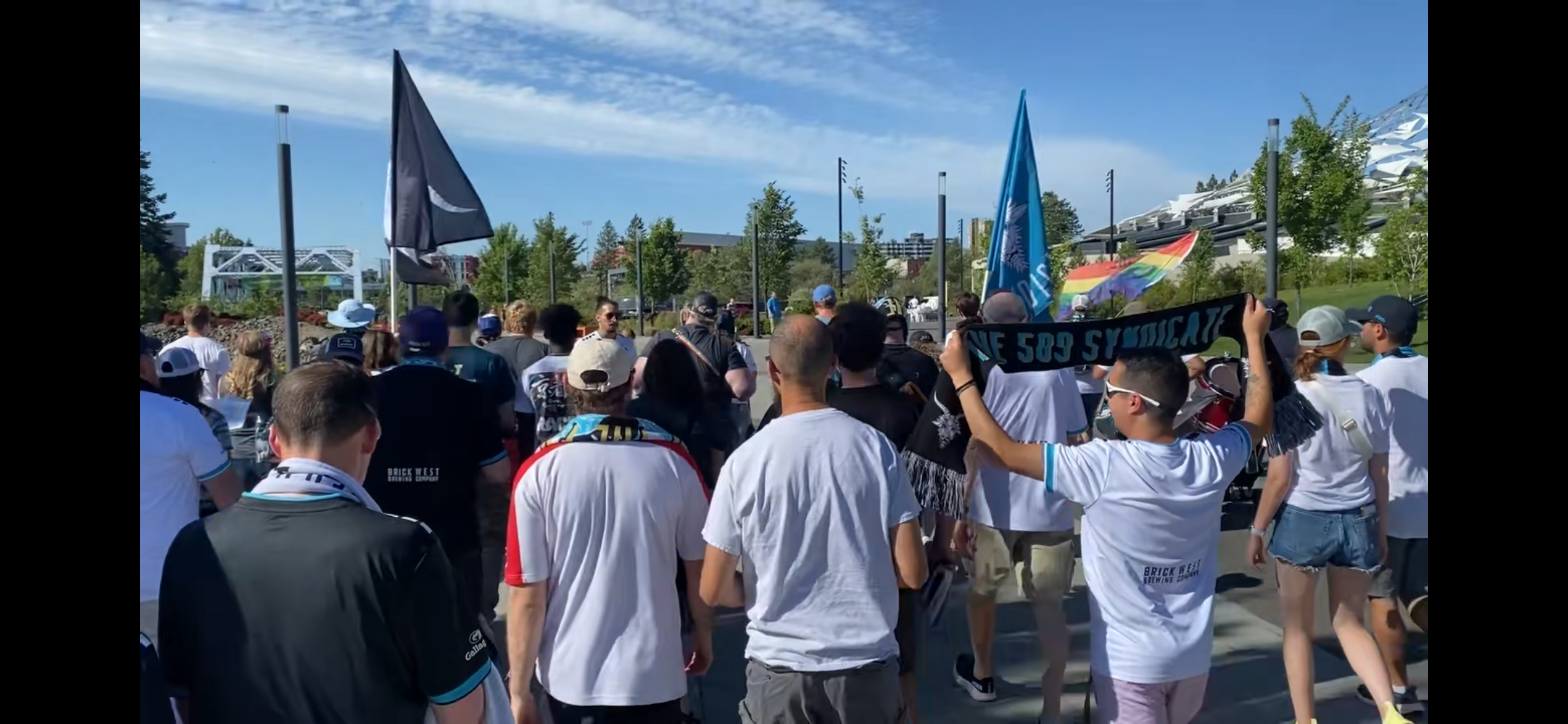 A crowd holding flags looking forward