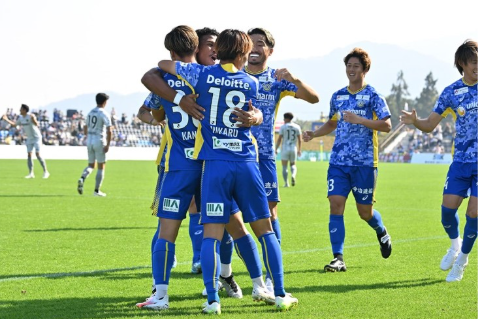 Team hugging while playing soccer