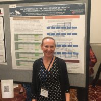 Dr. Gartstein standing next to a presentation board