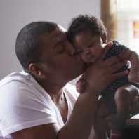 Dad cheek to cheek with baby