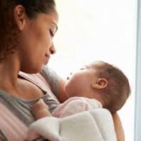 Mother holding infant gazing at each other
