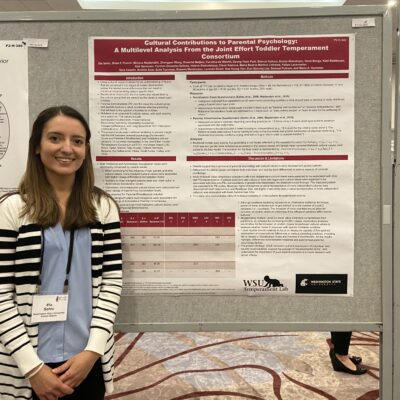 Female student standing next to a presentation board