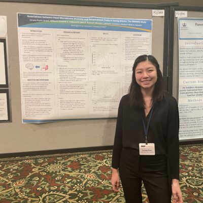 Female student standing next to a presentation board