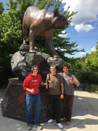 Tobias Conover, Nathan and August standing next to the bronze cougar statue.
