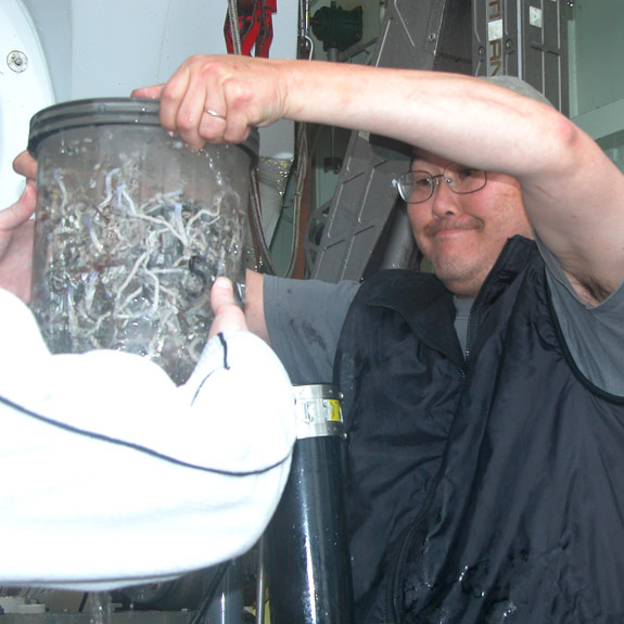 Associate professor Ray Lee, scientific director of the cruise, unloads the biobox holding tube worms and other deep-sea creatures picked up from Alvin's mechanical arms. Photo courtesy John Rutherford.