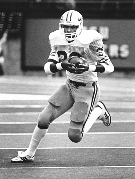 Rueben Mayes '92, '00 M.B.A, carries the ball in the historic 1984 game against Oregon. Photo Kevin Morris-U. Oregon.