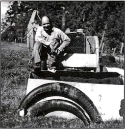 Emanuel Manis with the two tusks he dug up in his front yard.