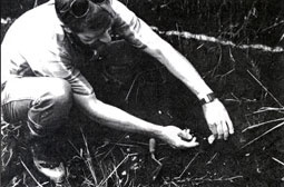 Dr. Carl Gustafson examining stone flake found below Mazama ash