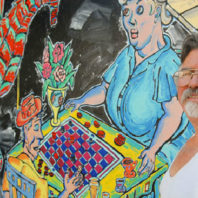 Patrick Siler next to mural in Pullman