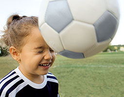 Girl heading a soccer ball