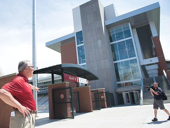 Bill Moos by football building